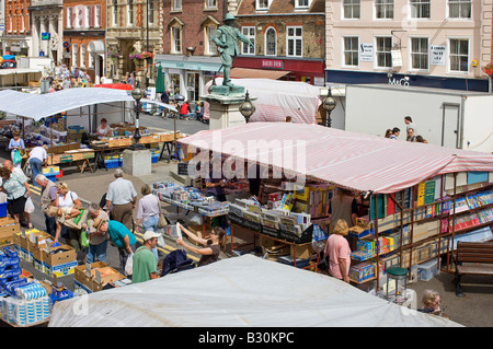 A view looking down on Market Hill and the statue of Oliver Cromwell, from a window in the Golden Lion Hotel, on  market day. Stock Photo