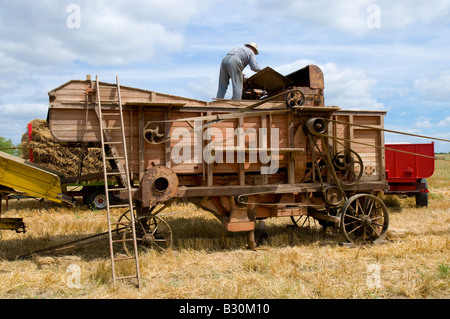 French farmer checking old thresher at agricultural show, Indre, France. Stock Photo