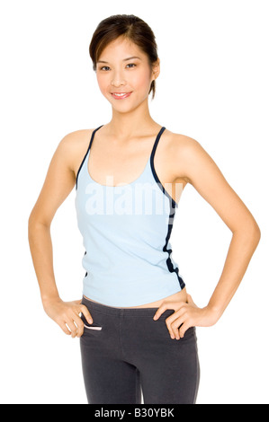 A smiling healthy young asian woman in sports clothing Stock Photo