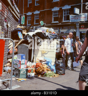 Overflowing rubbish heaping up on the corner of Brick Lane and Hanley Street London England UK Stock Photo