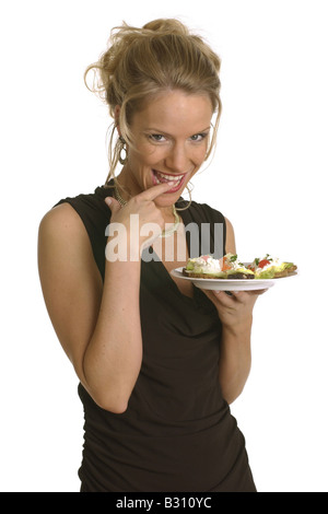 young woman clad in a party dress with some canapés Stock Photo