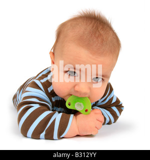 baby with comforter lying on its belly Stock Photo