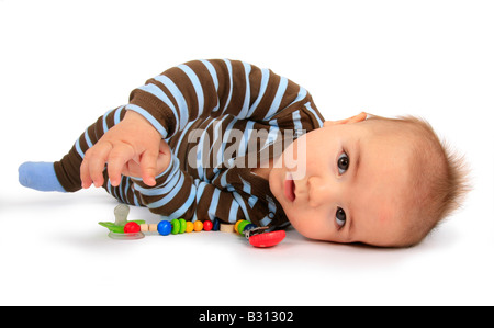 baby with pacifier keeper lying on the side Stock Photo