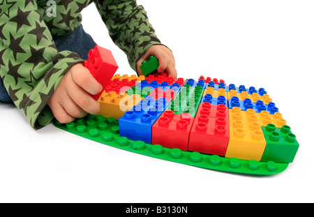 little boy playing with Lego bricks Stock Photo