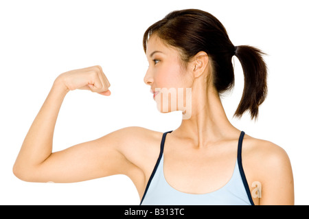 A pretty young asian woman flexing her arm Stock Photo