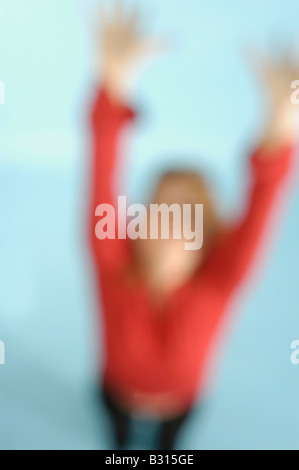 female figure puts arms in the air creatively blurred Stock Photo