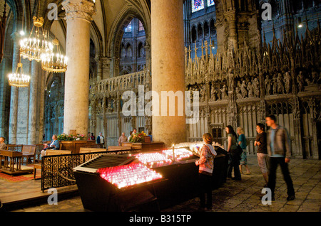 Lighting candles in The Cathedral of Our Lady of Chartres in France Stock Photo