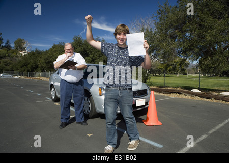 Teen boy passes driving test Stock Photo