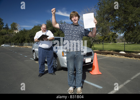 Teen boy passes driving test Stock Photo