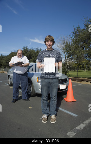 Teen boy passes driving test Stock Photo