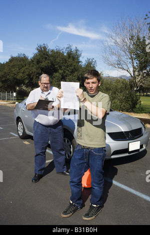 Teen boy passes driving test Stock Photo