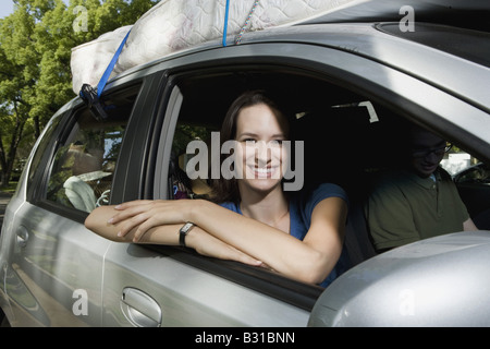 Young woman in Chevy Aveo leaving for college Stock Photo