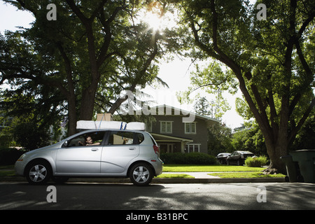 Young woman in Chevy Aveo leaving for college Stock Photo