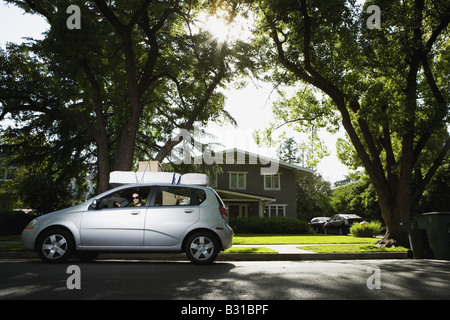 Young woman in Chevy Aveo leaving for college Stock Photo