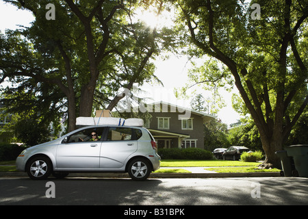 Young woman in Chevy Aveo leaving for college Stock Photo