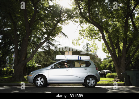 Young woman in Chevy Aveo leaving for college Stock Photo