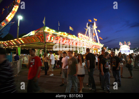 Bumper cars or scooters funfair ride from distance with mass of bright lights on top of square structure. Stock Photo