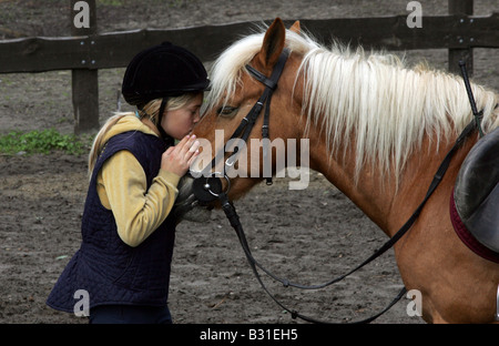 Girl kissing a pony Stock Photo