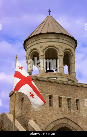 Georgian flag over orthodox monastery with blue sky Stock Photo