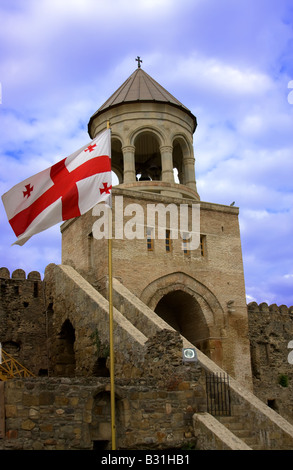 Georgian national red flag over orthodox church and blue sky Stock Photo