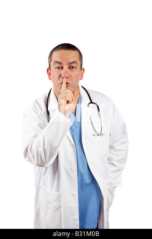 Friendly male doctor in lab coat making a gesture to be silence Stock Photo