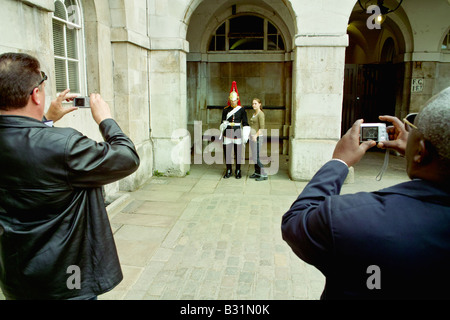 Tourists taking photos at Horseguards parade royal  horse guards Whitehall London UK england britain tourism pictures Stock Photo