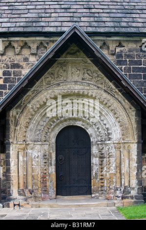 The sculptured stonework round the south door of St John the Baptist Adel Church Leeds West Yorkshire England UK Europe August Stock Photo