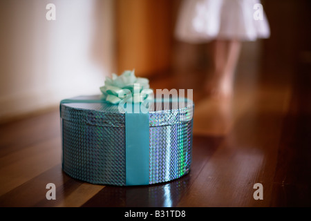 Five year old girl with green box wrapped in ribbon and rose Stock Photo