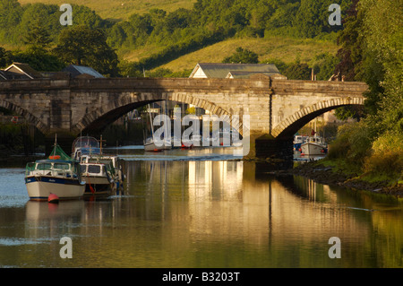 Moored boats in dawn light on the River Dart at Totnes bridge on a Summer morning Devon UK