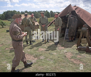 Home Guard soldiers by tents at their camp during 1940s world war two re-enactment Stock Photo