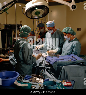 Surgeons, nurse and staff in an operating room in a hospital Stock Photo
