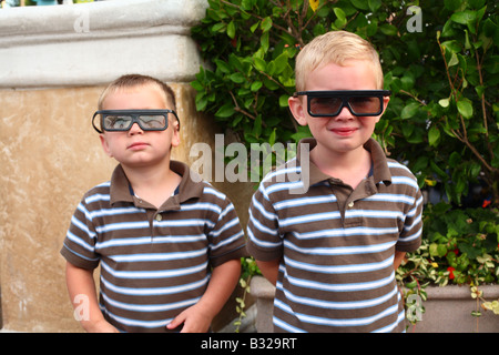 Two young boys wearing funny glasses