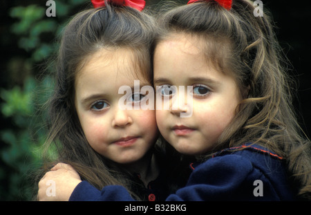 pair of dark haired twin girls aged around four years Stock Photo - Alamy