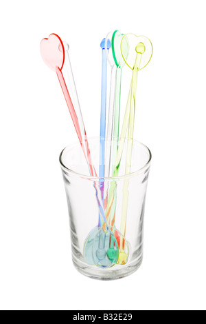 Colorful plastic swizzle sticks in glass on white background Stock Photo