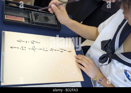 Japanese high school student practices calligraphy Stock Photo