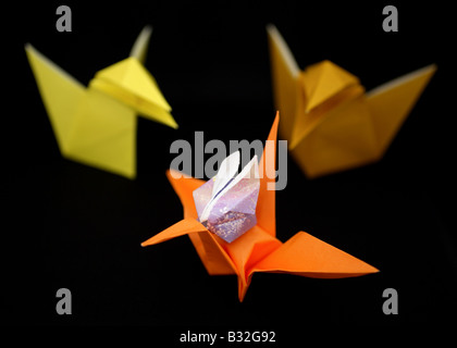 Origami crows, a crane and a rabbit. Stock Photo