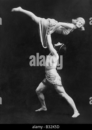 Male dancer holding female dancer aloft Stock Photo