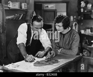 Man and woman collaborating on illustration Stock Photo