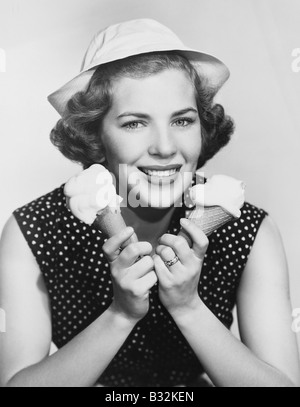 Portrait of woman with two ice cream cones Stock Photo