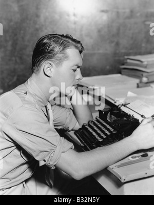 Man using typewriter Stock Photo