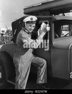 Portrait of man washing car windows Stock Photo