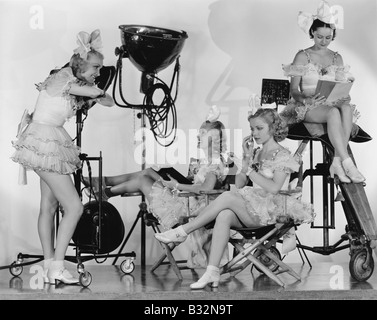 Women in costumes with movie equipment Stock Photo