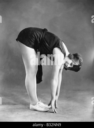 Woman touching toes Stock Photo