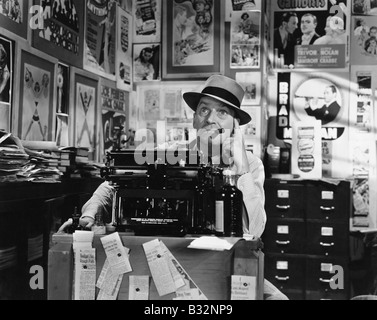 Man thinking at typewriter Stock Photo
