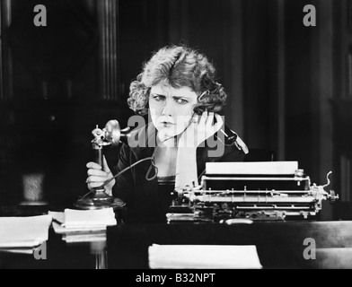 Confused woman on telephone Stock Photo