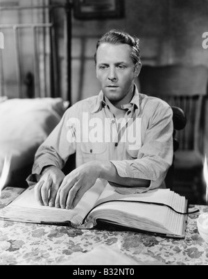 Blind man reading book in Braille Stock Photo