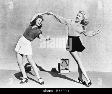 Two women dancing outside Stock Photo