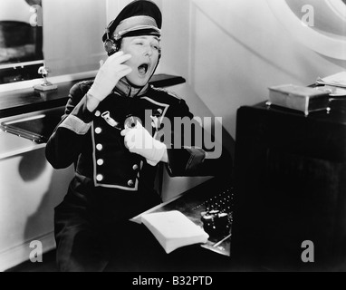 Yawning switchboard operator Stock Photo