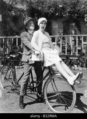 Couple sitting on a tandem bicycle Stock Photo