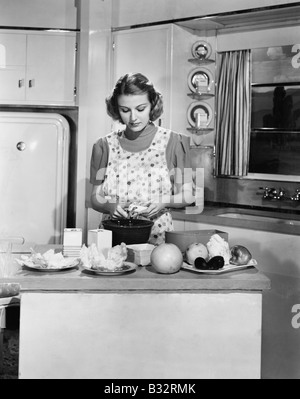 Young woman preparing food in the kitchen Stock Photo